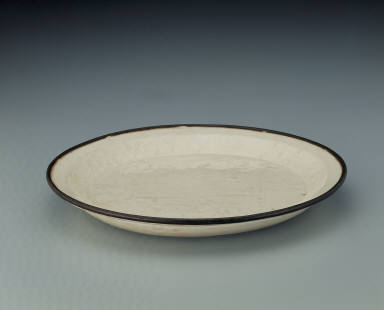 Dish with impressed scene of children at play in white glaze