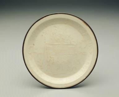 Dish with impressed scene of children at play in white glaze