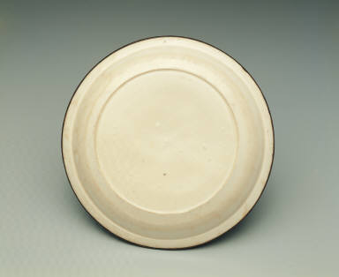 Dish with impressed scene of children at play in white glaze