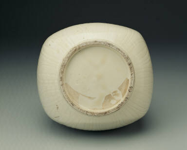 Squarish ewer with applied mask and dragon shaped handles in white glaze