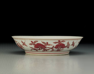 Dish with flowers and fruits in red enamel
