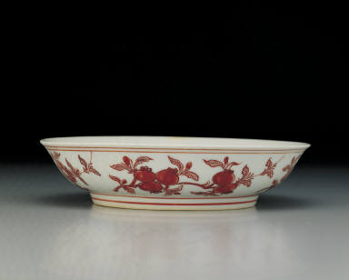 Dish with flowers and fruits in red enamel