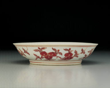 Dish with flowers and fruits in red enamel