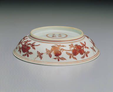 Dish with flowers and fruits in red enamel