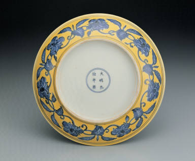 Dish with flowers and fruits in underglaze blue on a yellow ground