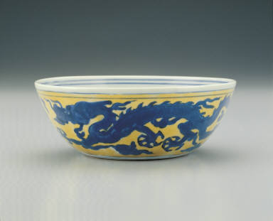 Bowl with dragons chasing pearls in underglaze blue on a yellow ground
