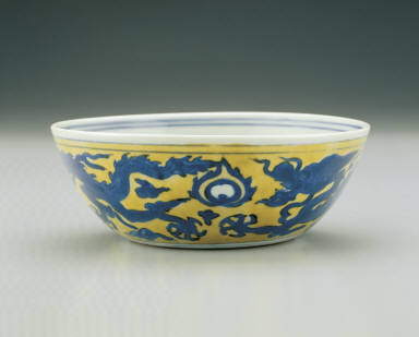 Bowl with dragons chasing pearls in underglaze blue on a yellow ground