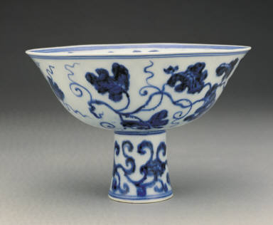 Stem bowl with design of fungus and grapes in undergraze blue