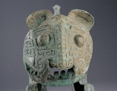 Bronze tiger with two tails and a bird on its back