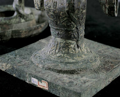 Bronze lamp with support of silver-headed human figure