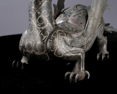 Bronze winged mythical animal inlaid with silver