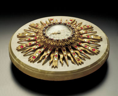 Gilt colck in the shape of sun