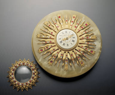 Gilt colck in the shape of sun