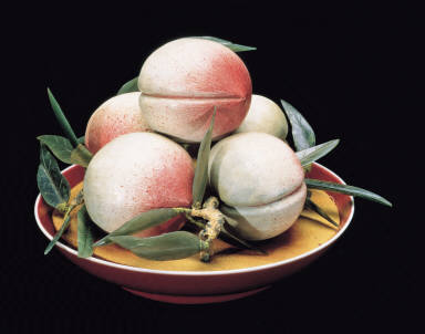 Wood carving of peaches and porcelain plate