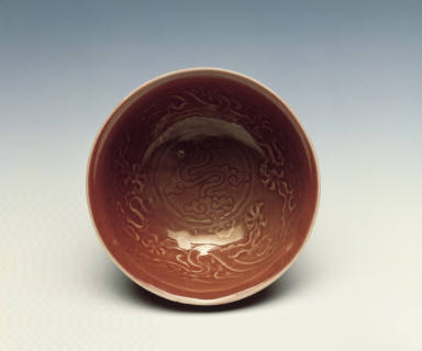 A molded copper-red bowl