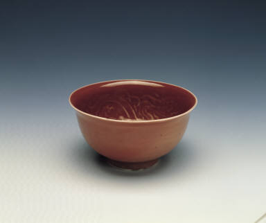 A molded copper-red bowl