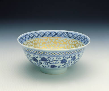 A blue-and-white bowl with inlaid gold and lotus pond motif